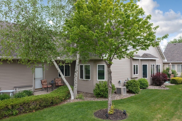 145 Bluebird Ln, Clearwater, MN 55320 - rear view of property featuring a shingled roof, a lawn, and central air condition unit