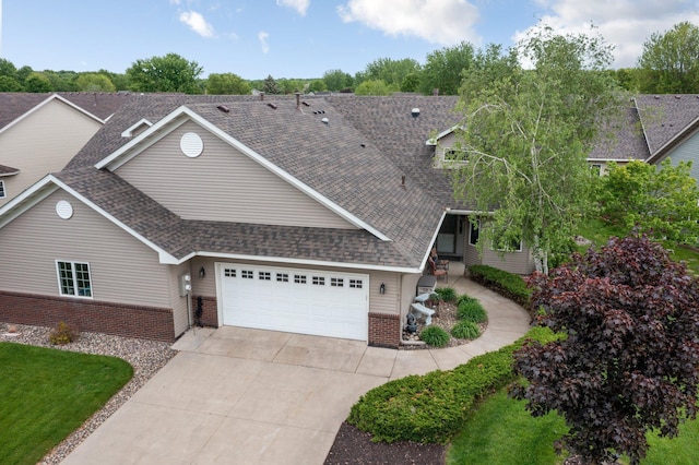 145 Bluebird Ln, Clearwater, MN 55320 - view of front of home featuring brick siding, a garage, a shingled roof, and concrete driveway