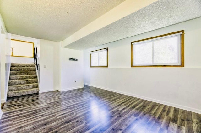 9705 99th Ave N, Maple Grove, MN 55369 - unfurnished room with a textured ceiling, dark wood-type flooring, stairs, and baseboards