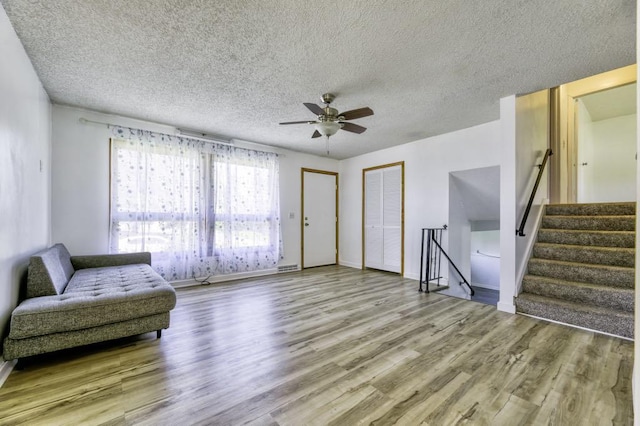 9705 99th Ave N, Maple Grove, MN 55369 - living area with wood finished floors, ceiling fan, a textured ceiling, baseboards, and stairs