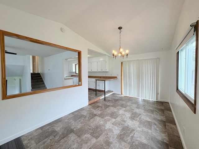 9705 99th Ave N, Maple Grove, MN 55369 - empty room featuring baseboards, a chandelier, vaulted ceiling, stone finish floors, and stairway