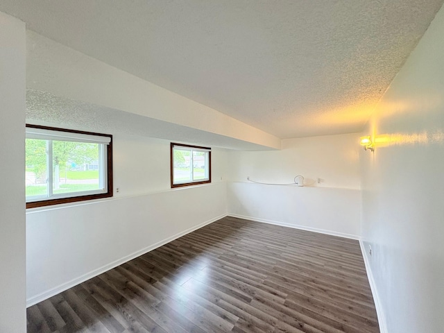 9705 99th Ave N, Maple Grove, MN 55369 - empty room featuring a textured ceiling, dark wood finished floors, and baseboards