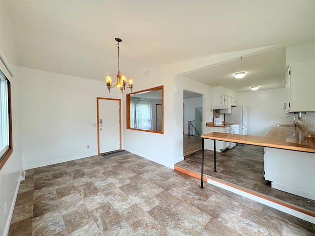 9705 99th Ave N, Maple Grove, MN 55369 - kitchen featuring a sink, a chandelier, light countertops, white cabinets, and stone finish floors