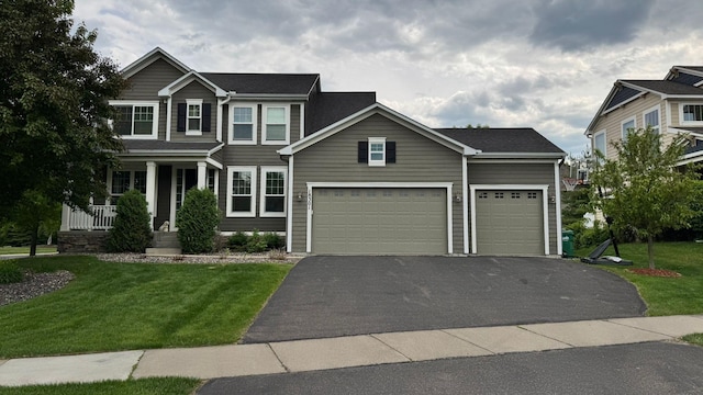 18301 100th Ave N, Osseo, MN 55311 - view of front of home featuring driveway, a front yard, and covered porch