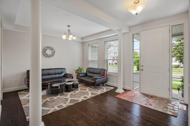 18301 100th Ave N, Osseo, MN 55311 - entryway featuring ornate columns, baseboards, healthy amount of natural light, wood finished floors, and a textured ceiling