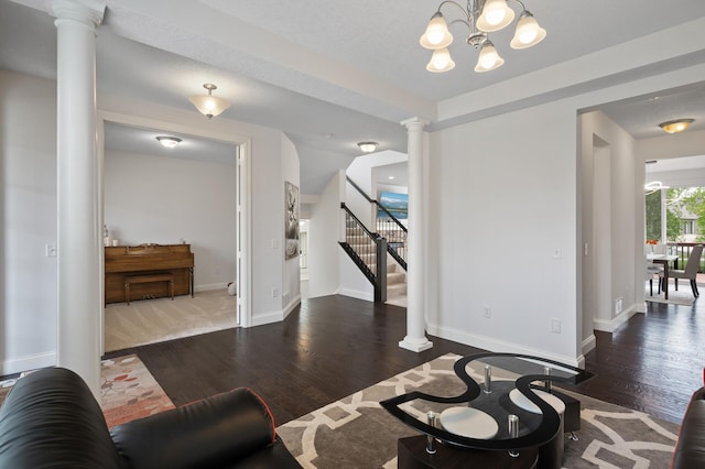 18301 100th Ave N, Osseo, MN 55311 - living area with decorative columns, wood finished floors, a chandelier, baseboards, and stairway
