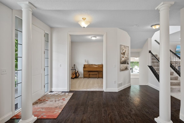 18301 100th Ave N, Osseo, MN 55311 - foyer featuring decorative columns, hardwood / wood-style floors, and baseboards