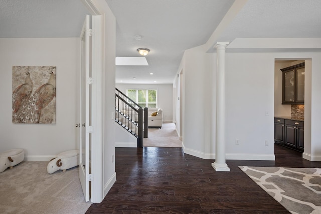 18301 100th Ave N, Osseo, MN 55311 - corridor with ornate columns, stairway, dark wood-style flooring, baseboards, and a skylight