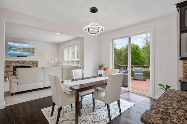18301 100th Ave N, Osseo, MN 55311 - dining area featuring a fireplace, plenty of natural light, dark wood-style flooring, recessed lighting, and baseboards