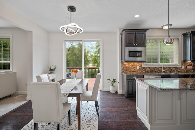18301 100th Ave N, Osseo, MN 55311 - dining space with a chandelier, baseboards, recessed lighting, and dark wood-style flooring