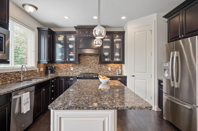 18301 100th Ave N, Osseo, MN 55311 - kitchen featuring stainless steel appliances, ventilation hood, a sink, dark wood finished floors, and glass insert cabinets