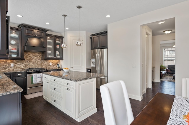 18301 100th Ave N, Osseo, MN 55311 - kitchen featuring stainless steel appliances, custom range hood, dark wood-type flooring, tasteful backsplash, and a kitchen island
