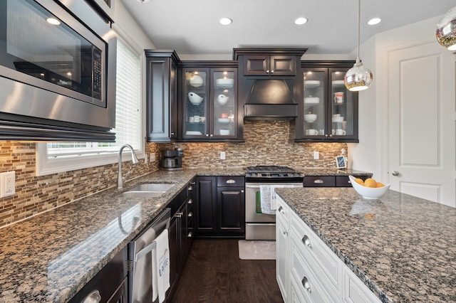 18301 100th Ave N, Osseo, MN 55311 - kitchen with stainless steel appliances, custom exhaust hood, a sink, glass insert cabinets, and dark wood-type flooring