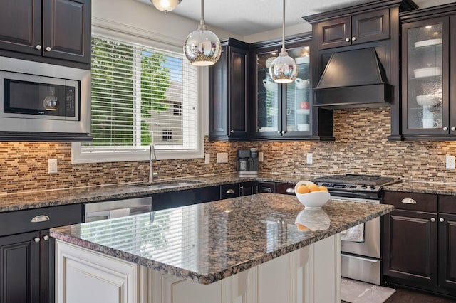 18301 100th Ave N, Osseo, MN 55311 - kitchen with premium range hood, appliances with stainless steel finishes, a sink, backsplash, and dark stone counters