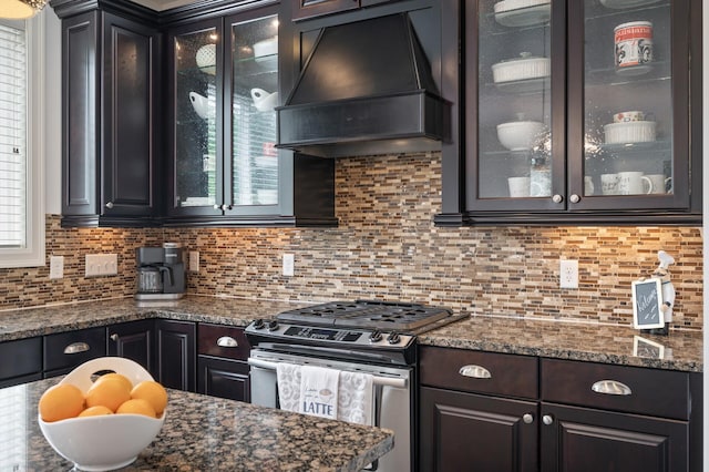 18301 100th Ave N, Osseo, MN 55311 - kitchen featuring stainless steel gas range, custom range hood, decorative backsplash, and glass insert cabinets