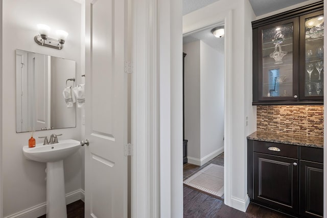 18301 100th Ave N, Osseo, MN 55311 - bathroom with baseboards, tasteful backsplash, wood finished floors, and a sink