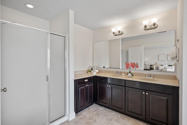 18301 100th Ave N, Osseo, MN 55311 - full bath featuring a shower stall, double vanity, ensuite bathroom, a textured ceiling, and tile patterned flooring