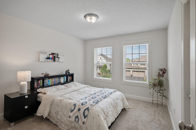 18301 100th Ave N, Osseo, MN 55311 - carpeted bedroom featuring a textured ceiling and baseboards