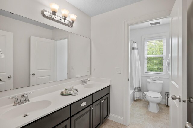 18301 100th Ave N, Osseo, MN 55311 - bathroom featuring double vanity, toilet, shower / bath combo with shower curtain, and baseboards