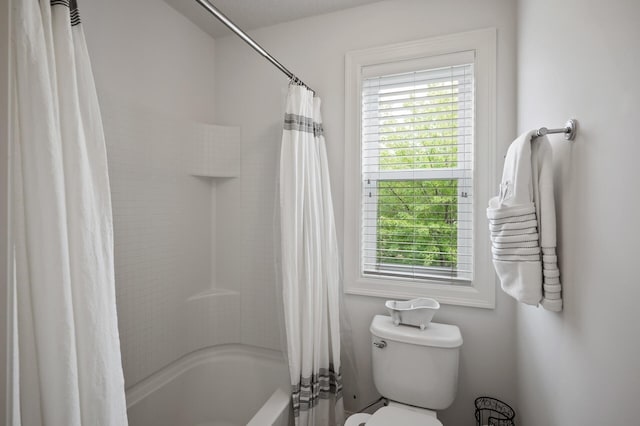 18301 100th Ave N, Osseo, MN 55311 - bathroom featuring healthy amount of natural light, toilet, and shower / bath combo with shower curtain