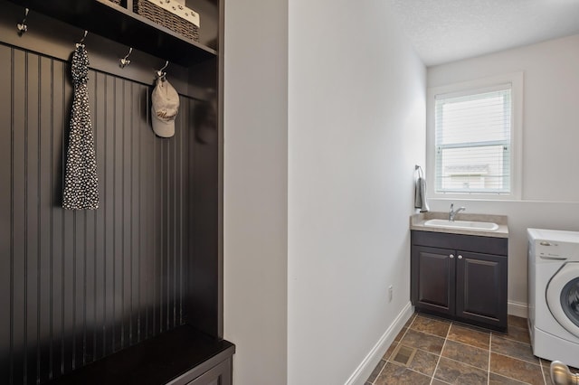 18301 100th Ave N, Osseo, MN 55311 - laundry room featuring washer / dryer, cabinet space, baseboards, and dark stone finish floors
