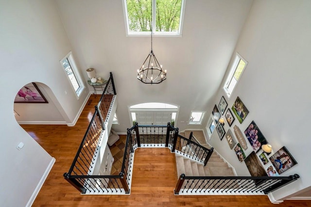 24534 474th Ln, Elysian Twp, MN 56028 - entrance foyer with a high ceiling, wood finished floors, baseboards, a chandelier, and plenty of natural light