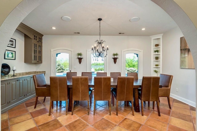 24534 474th Ln, Elysian Twp, MN 56028 - dining area with built in features, a chandelier, recessed lighting, arched walkways, and baseboards