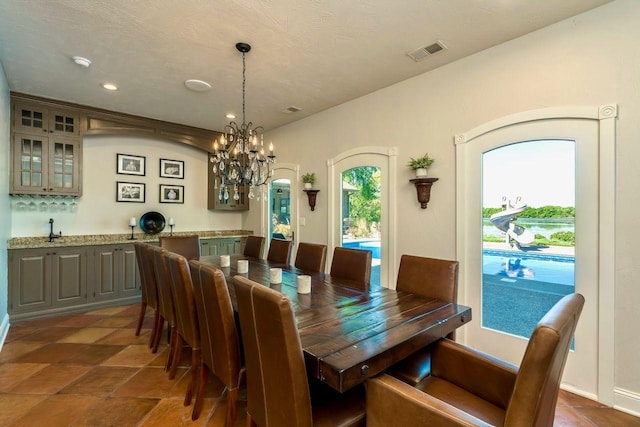 24534 474th Ln, Elysian Twp, MN 56028 - dining space with a chandelier, wet bar, recessed lighting, and arched walkways