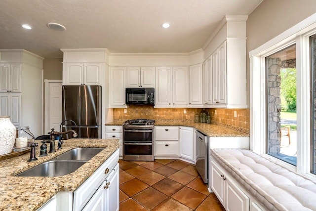 24534 474th Ln, Elysian Twp, MN 56028 - kitchen with stainless steel appliances, a sink, tasteful backsplash, white cabinetry, and recessed lighting