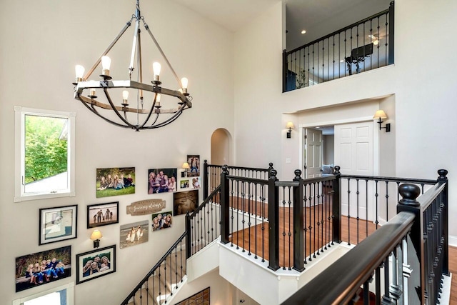 24534 474th Ln, Elysian Twp, MN 56028 - stairway featuring a towering ceiling, a chandelier, and baseboards