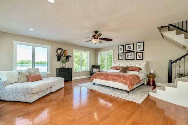 24534 474th Ln, Elysian Twp, MN 56028 - bedroom with baseboards, light wood-style flooring, recessed lighting, and a ceiling fan