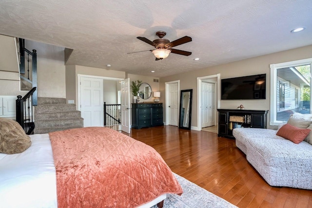 24534 474th Ln, Elysian Twp, MN 56028 - bedroom featuring wood finished floors, recessed lighting, a ceiling fan, baseboards, and a barn door