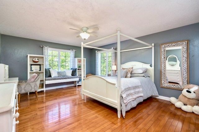 24534 474th Ln, Elysian Twp, MN 56028 - bedroom featuring light wood finished floors, a ceiling fan, and baseboards