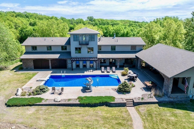 24534 474th Ln, Elysian Twp, MN 56028 - swimming pool featuring a wooded view, a patio, and a lawn