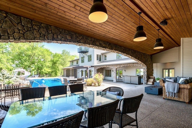 24534 474th Ln, Elysian Twp, MN 56028 - view of patio featuring outdoor dining area, an outdoor hangout area, a hot tub, an outdoor pool, and ceiling fan