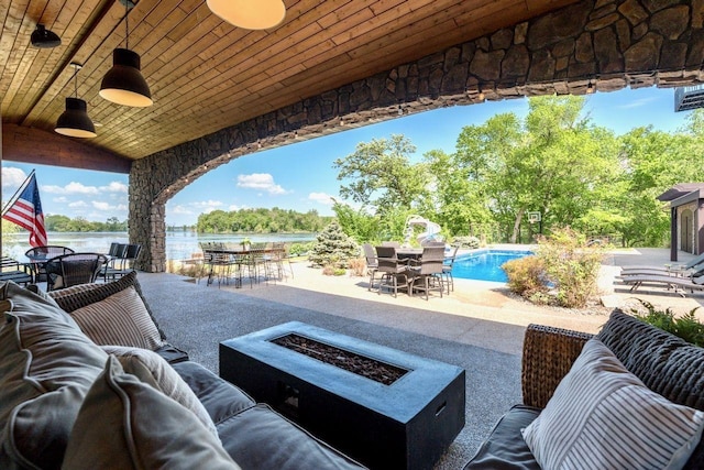 24534 474th Ln, Elysian Twp, MN 56028 - view of patio / terrace featuring outdoor dining area, an outdoor living space with a fire pit, an outdoor pool, a water view, and a ceiling fan