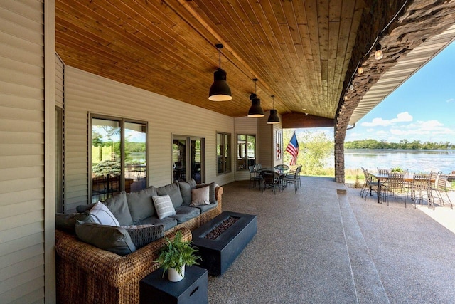 24534 474th Ln, Elysian Twp, MN 56028 - view of patio / terrace with outdoor dining area, an outdoor living space with a fire pit, and a water view