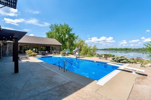 24534 474th Ln, Elysian Twp, MN 56028 - swimming pool featuring a water slide, a patio, a diving board, and a water view