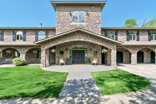 24534 474th Ln, Elysian Twp, MN 56028 - view of front of property featuring a front yard, stone siding, and french doors