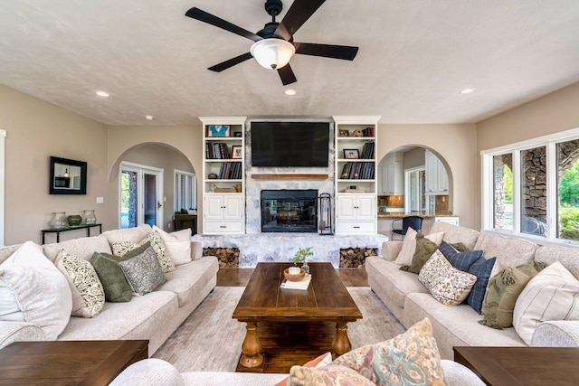 24534 474th Ln, Elysian Twp, MN 56028 - living area featuring arched walkways, ceiling fan, a fireplace, recessed lighting, and wood finished floors