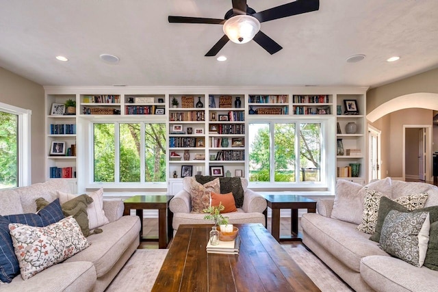 24534 474th Ln, Elysian Twp, MN 56028 - living area with arched walkways, built in shelves, ceiling fan, and recessed lighting