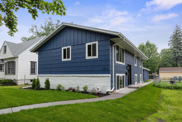 3936 Quail Ave N, Robbinsdale, MN 55422 - view of property exterior with a lawn and stone siding