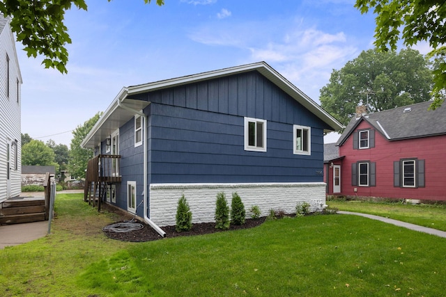 3936 Quail Ave N, Robbinsdale, MN 55422 - view of property exterior featuring a lawn and board and batten siding