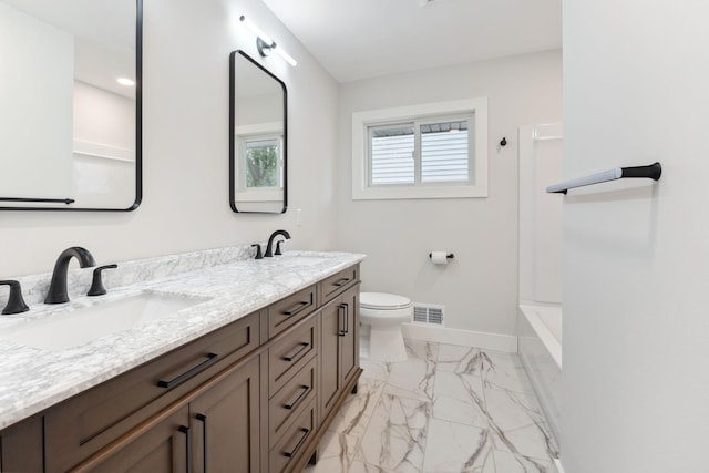 3936 Quail Ave N, Robbinsdale, MN 55422 - bathroom featuring baseboards, marble finish floors, double vanity, toilet, and  shower combination