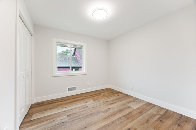 3936 Quail Ave N, Robbinsdale, MN 55422 - unfurnished bedroom featuring a closet, wood finished floors, and baseboards