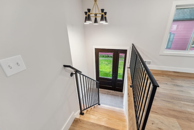 3936 Quail Ave N, Robbinsdale, MN 55422 - staircase with a chandelier, baseboards, and wood finished floors
