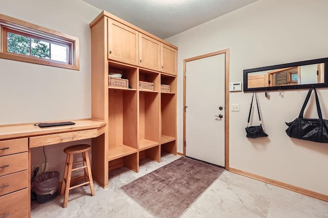 946 Wild Rose Ct, Eagan, MN 55123 - mudroom featuring light marble finish flooring and a textured ceiling