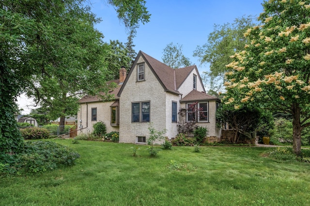 967 Stryker Ave W, Saint Paul, MN 55118 - view of front of home with a chimney, a front lawn, and a shingled roof