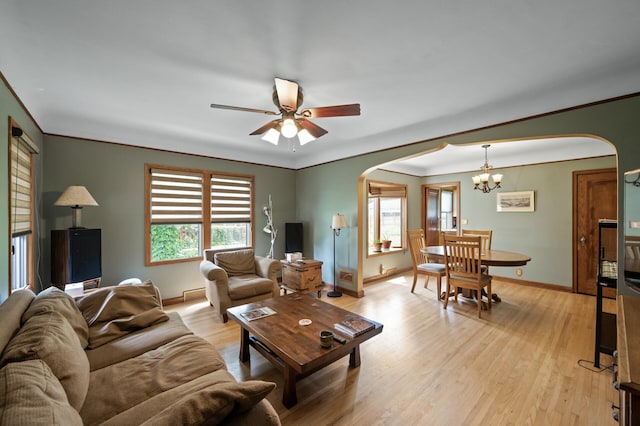 967 Stryker Ave W, Saint Paul, MN 55118 - living area featuring arched walkways, a chandelier, ceiling fan, light wood finished floors, and ornamental molding