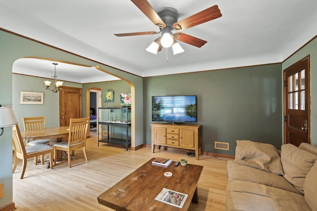 967 Stryker Ave W, Saint Paul, MN 55118 - living area featuring light wood finished floors, a chandelier, arched walkways, ceiling fan, and ornamental molding